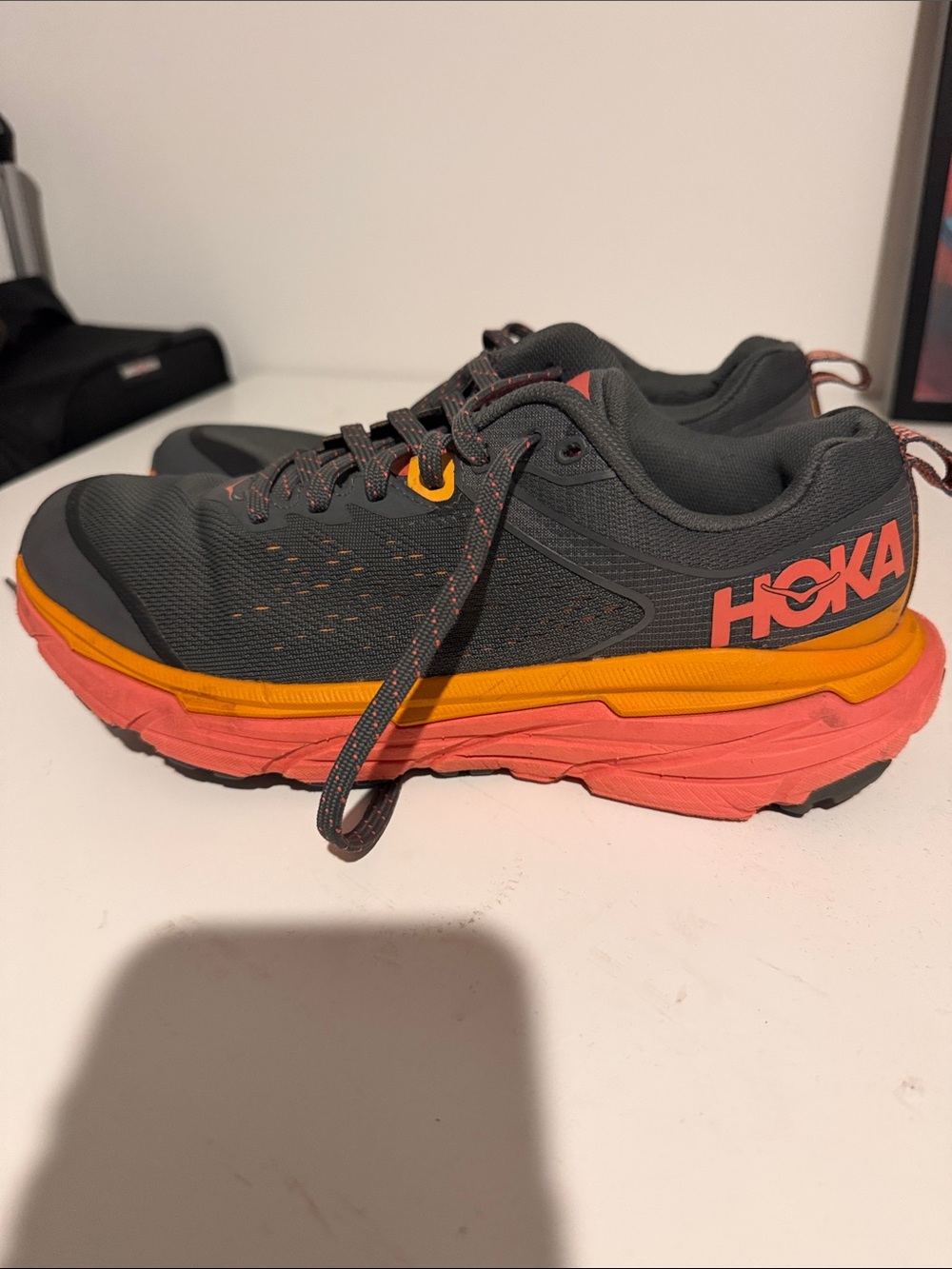Hoka Dark Gray Trail Runners with Orange and Coral Accents